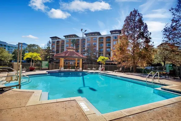 a view of swimming pool with outdoor seating and a garden
