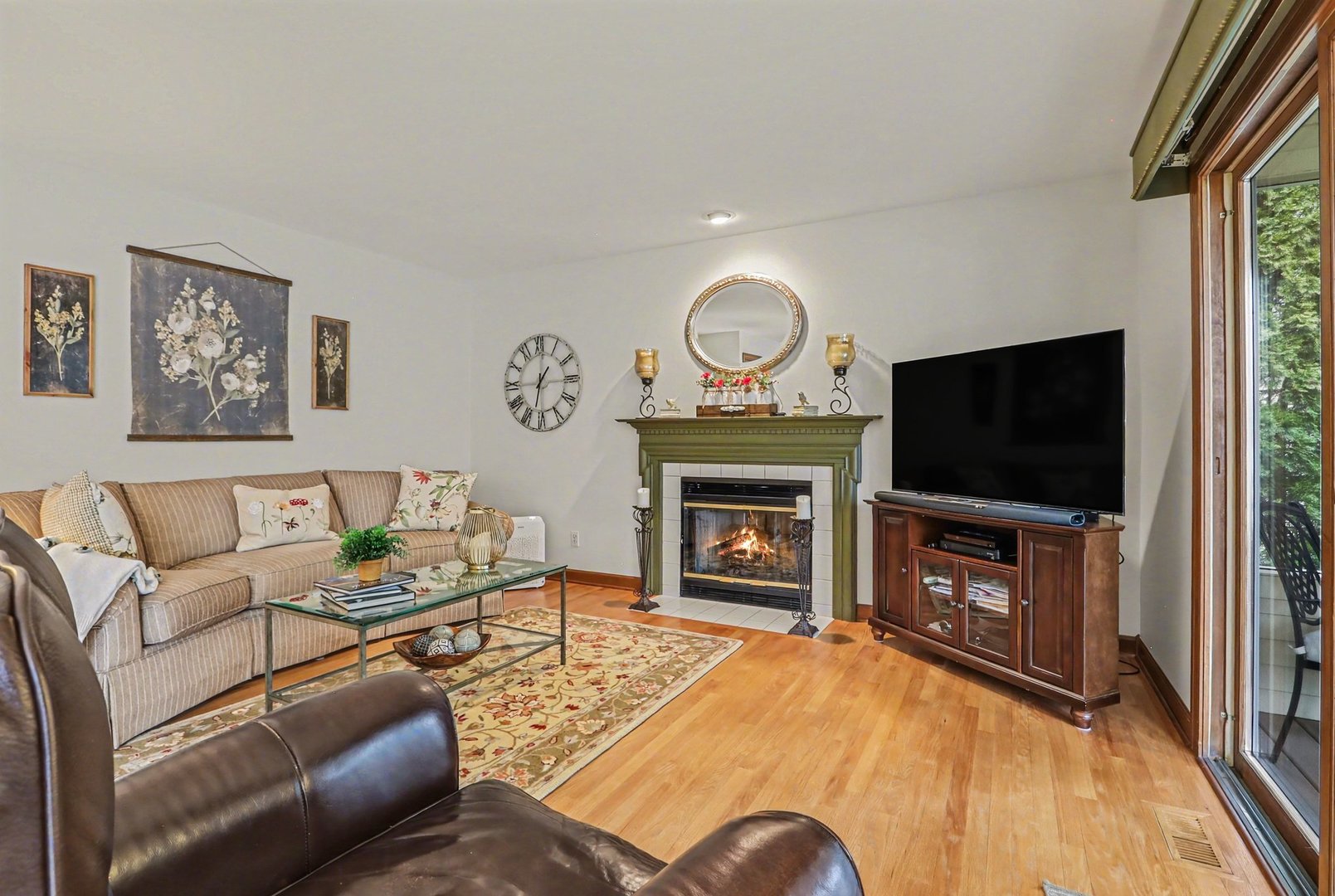 570 Violet Lane Batavia, IL 60510 - Photo 14 of 28 a living room with furniture a flat screen tv and a fireplace