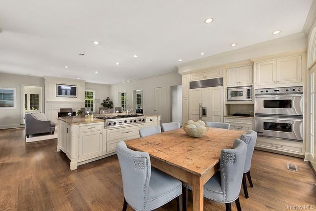a large kitchen with kitchen island a dining table and chairs