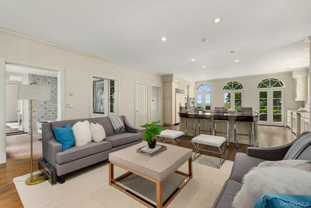 a living room with furniture and view of kitchen