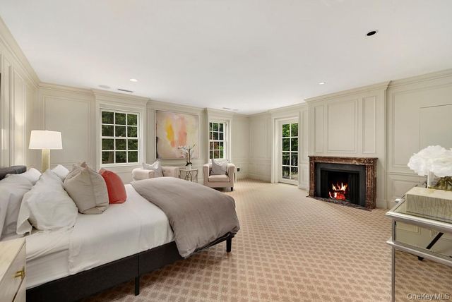 a bedroom with bed and a fireplace