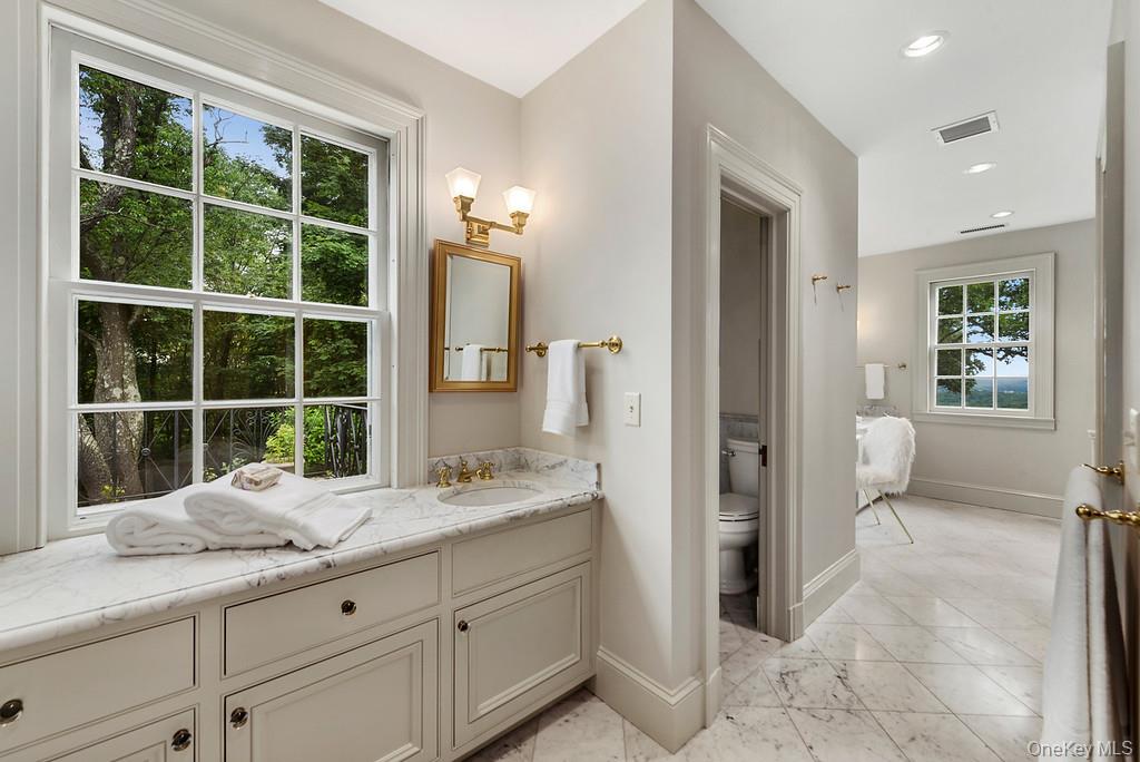 77 Oregon Road Bedford Corners, NY 10549 - Photo 17 of 27 a bathroom with a granite countertop sink a mirror and a shower