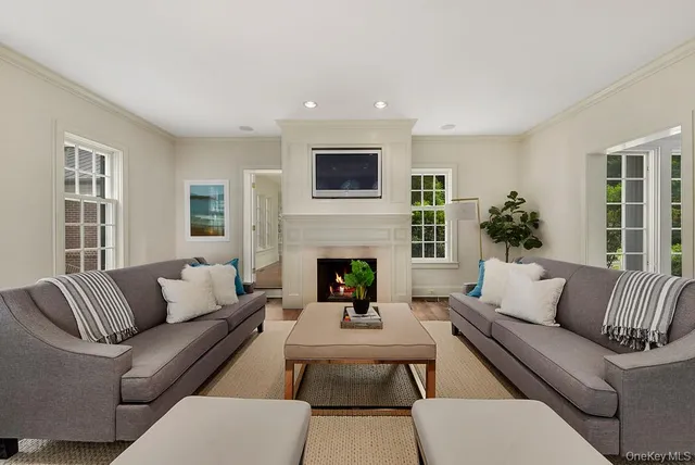 a living room with furniture fireplace and window