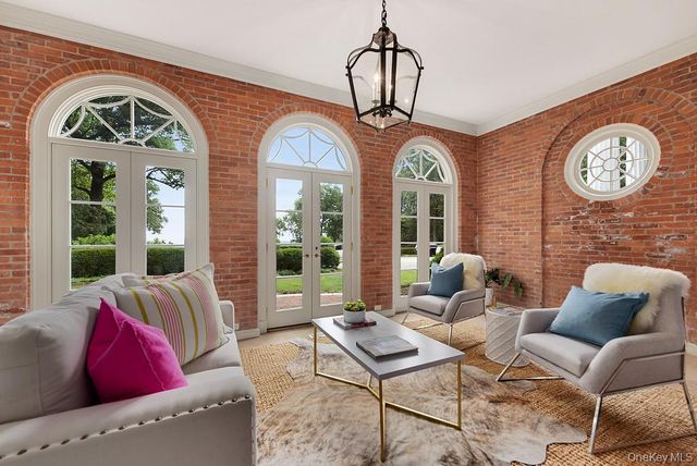a living room with furniture a table and a large window