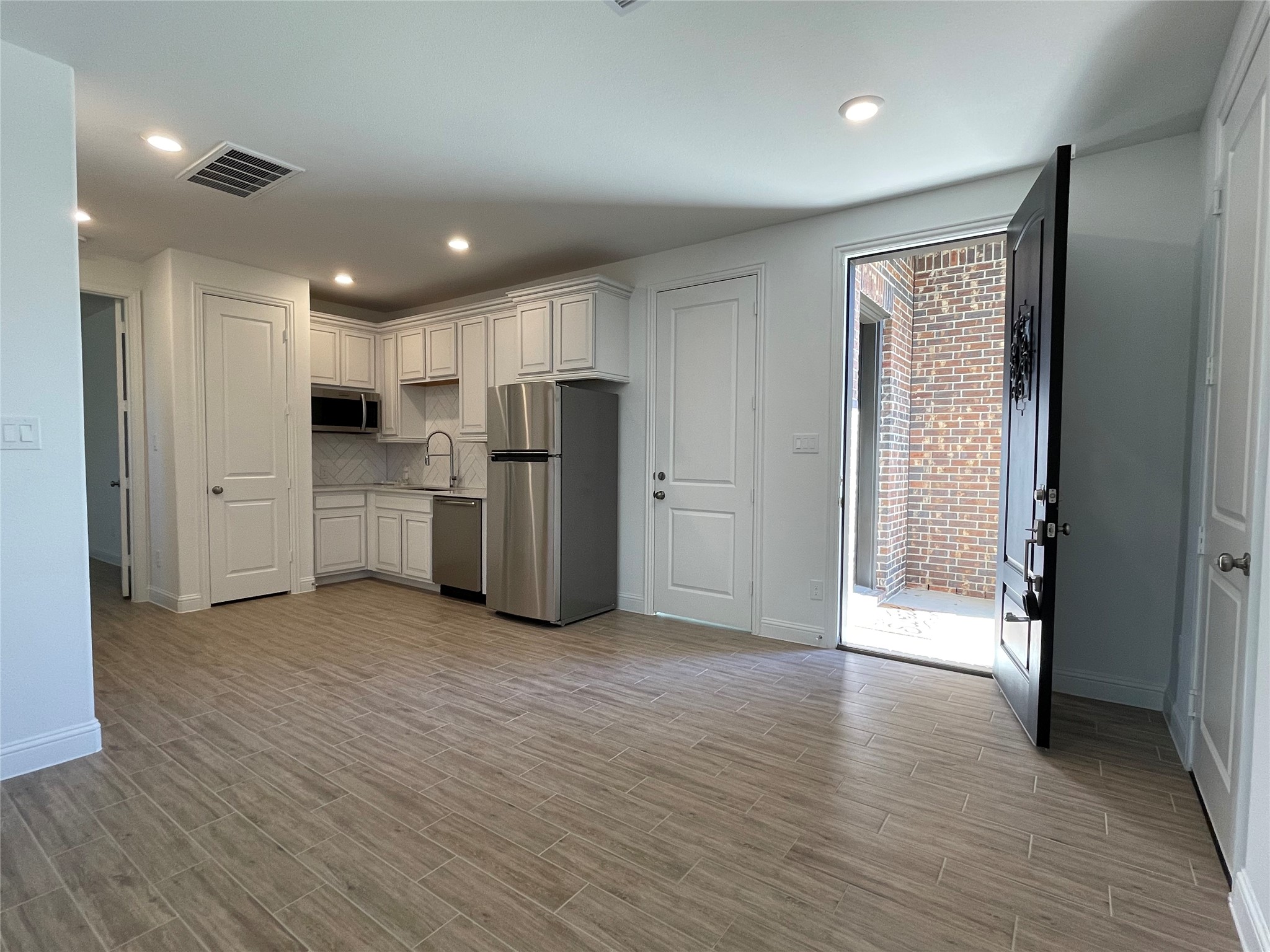 29806 Cherry Vine Road Katy, TX 77494 - Photo 27 of 30 a view of kitchen with refrigerator and wooden floor