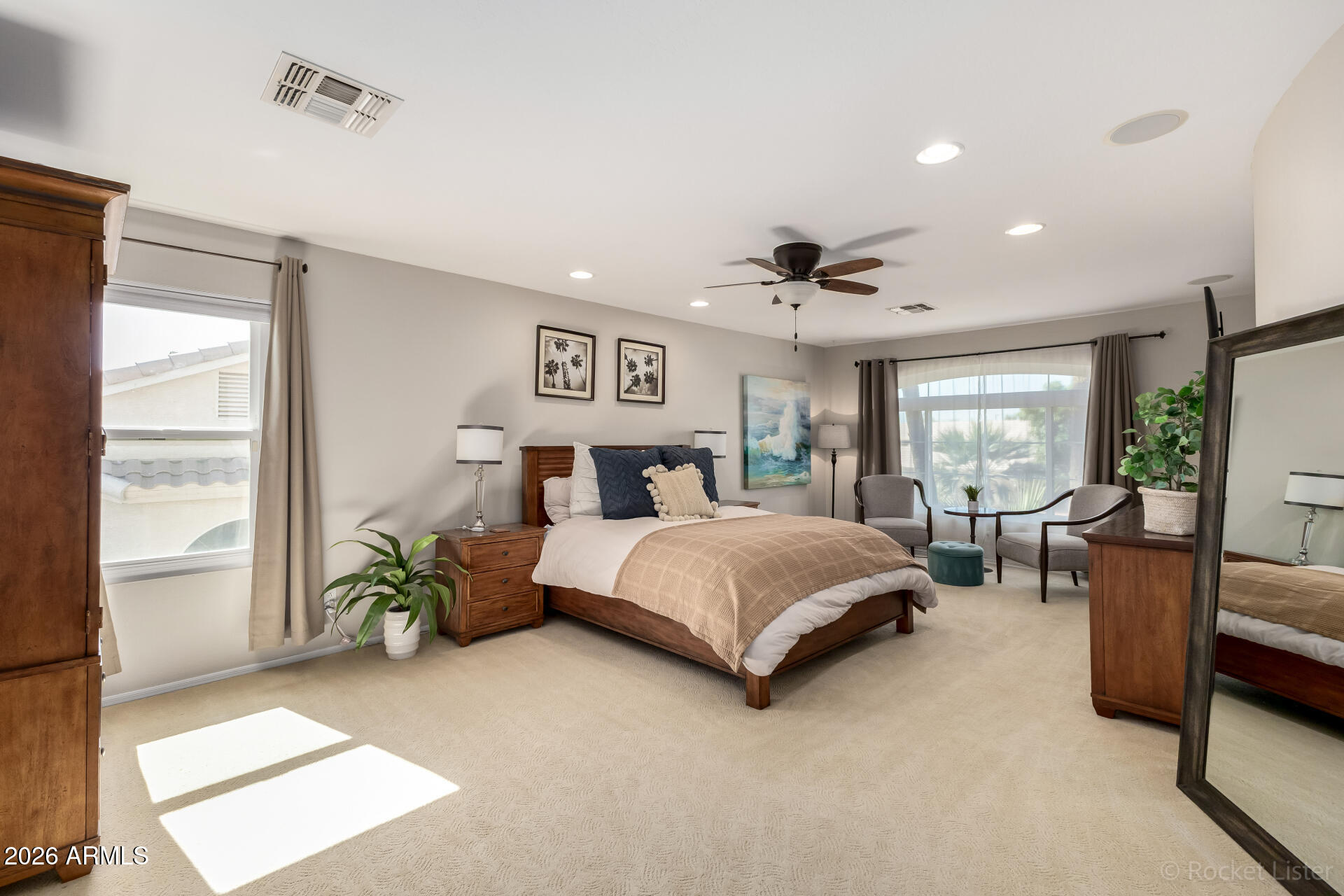 2611 East Catclaw Street Gilbert, AZ 85296 - Photo 13 of 29 a spacious bedroom with a bed and a couch