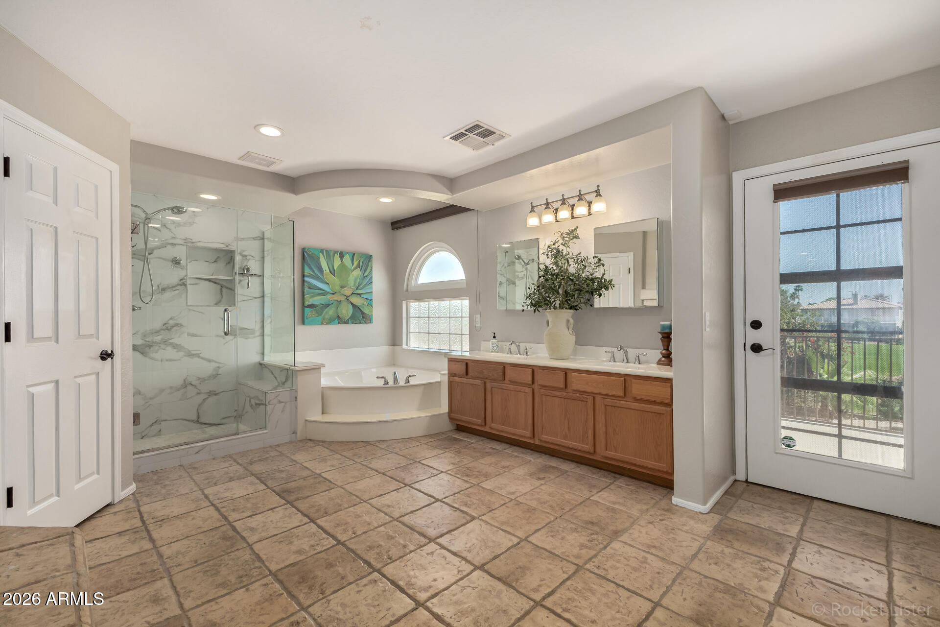 2611 East Catclaw Street Gilbert, AZ 85296 - Photo 15 of 29 a large bathroom with a glass door shower a sink and a mirror