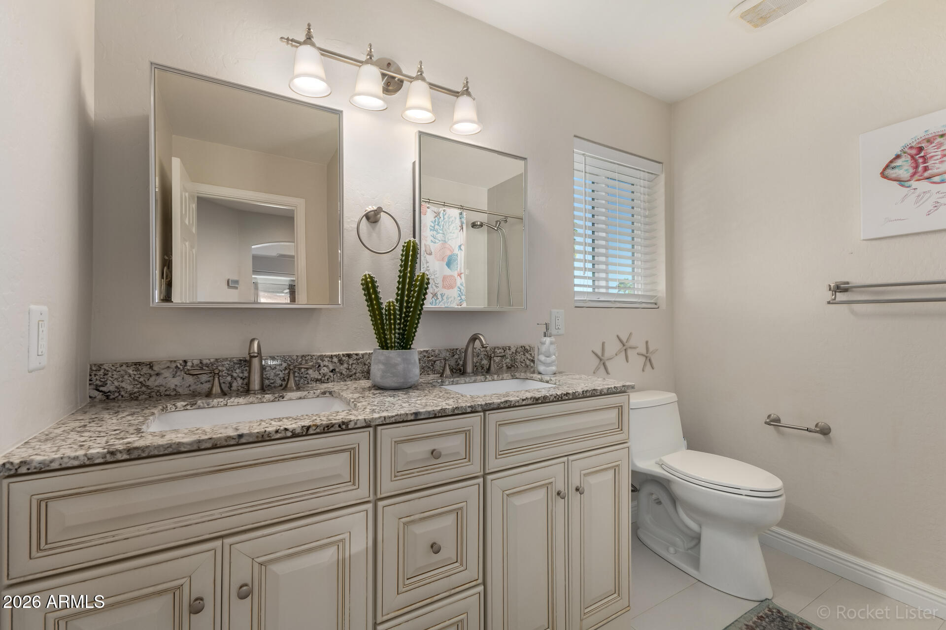 2611 East Catclaw Street Gilbert, AZ 85296 - Photo 19 of 29 a bathroom with a granite countertop toilet sink and mirror