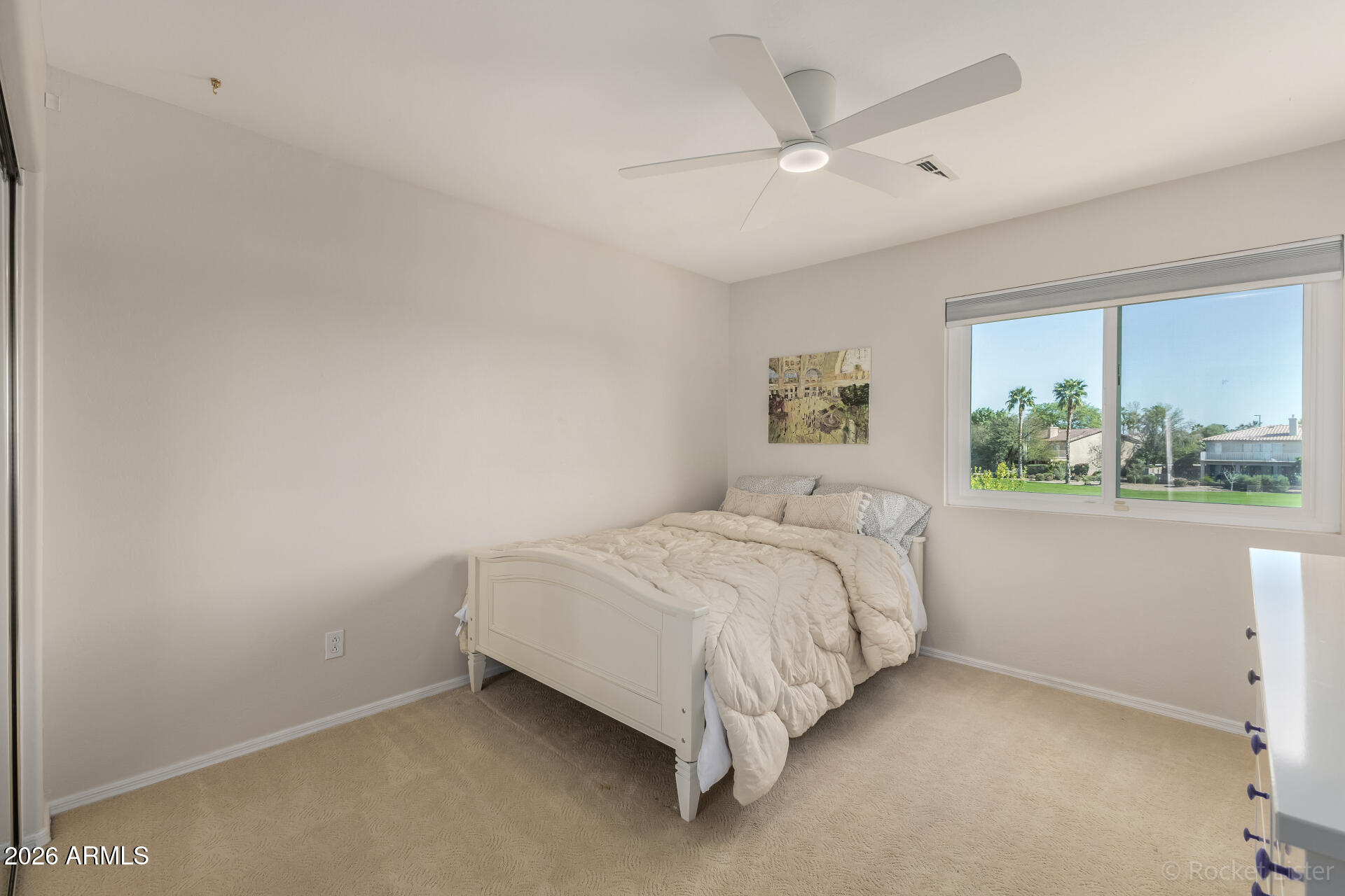 2611 East Catclaw Street Gilbert, AZ 85296 - Photo 20 of 29 a bed sitting in a bedroom next to a window
