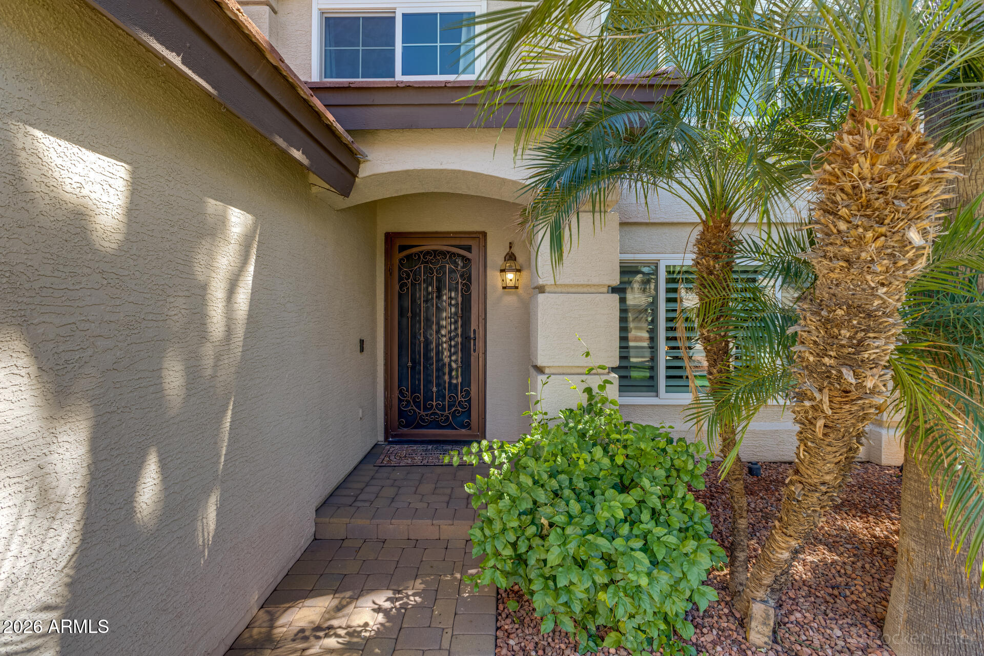 2611 East Catclaw Street Gilbert, AZ 85296 - Photo 2 of 29 a front view of a house with a glass door