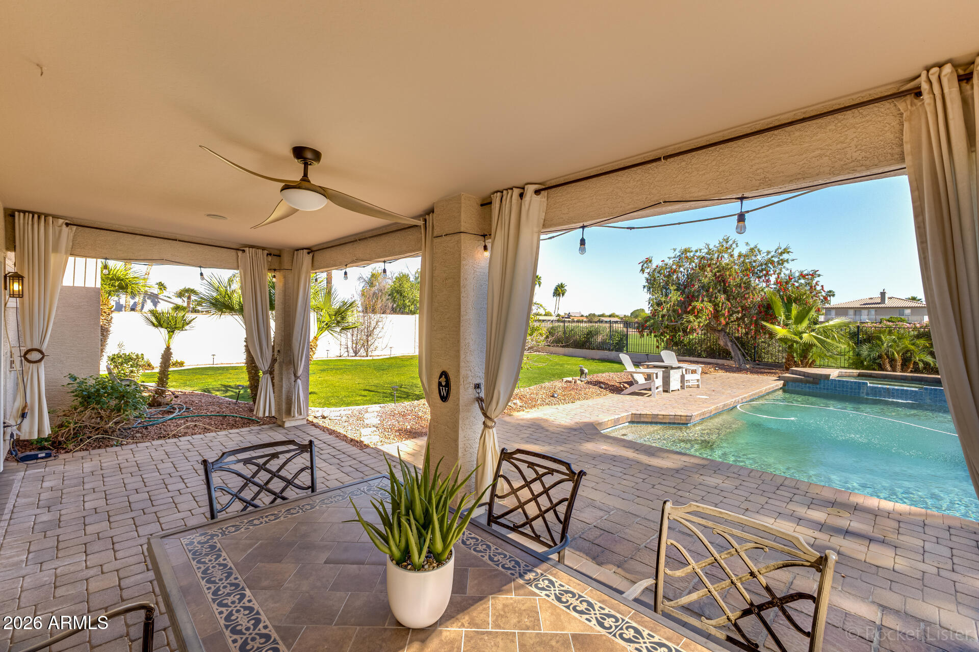 2611 East Catclaw Street Gilbert, AZ 85296 - Photo 22 of 29 a view of a porch with furniture and garden