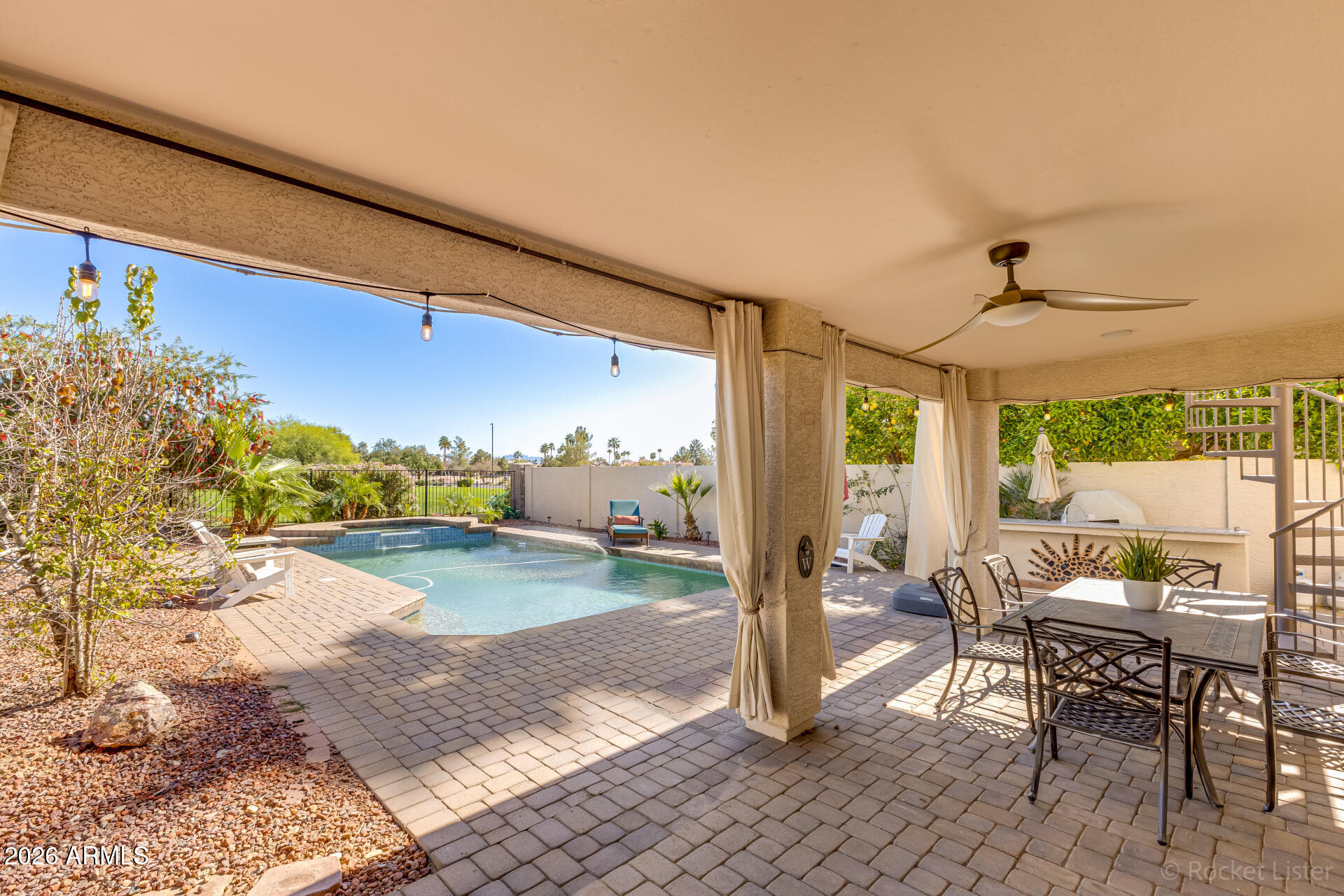 2611 East Catclaw Street Gilbert, AZ 85296 - Photo 23 of 29 a view of a patio with dining table and chairs with wooden floor