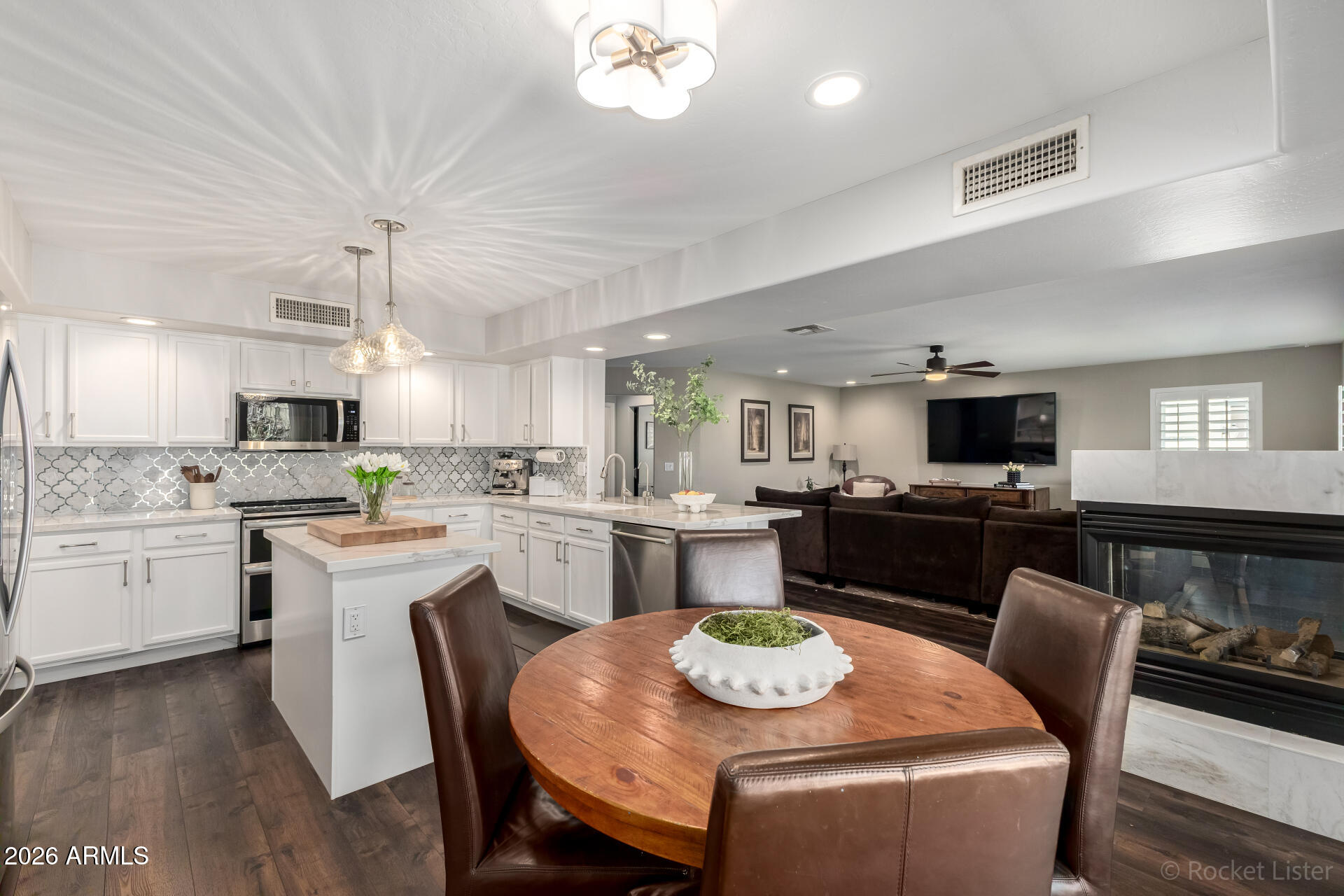 2611 East Catclaw Street Gilbert, AZ 85296 - Photo 7 of 29 a kitchen with a dining table chairs and microwave