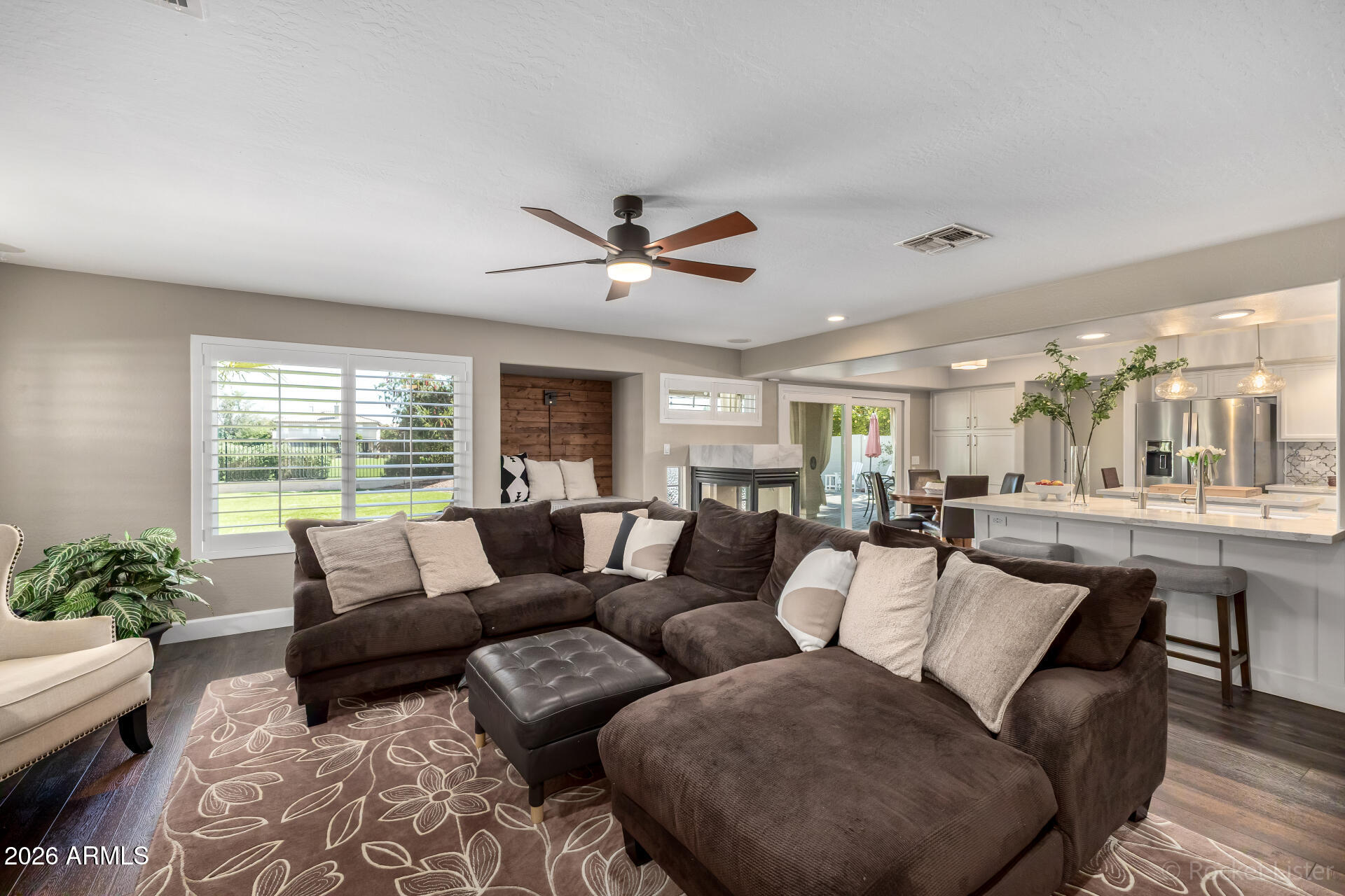 2611 East Catclaw Street Gilbert, AZ 85296 - Photo 9 of 29 a living room with furniture ceiling fan and a large window