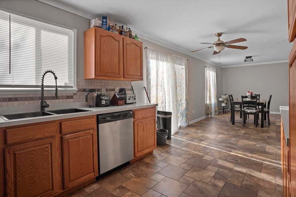 232 Stamford Lane Romeoville, IL 60446 - Photo 12 of 48 a kitchen with stainless steel appliances granite countertop a sink and cabinets