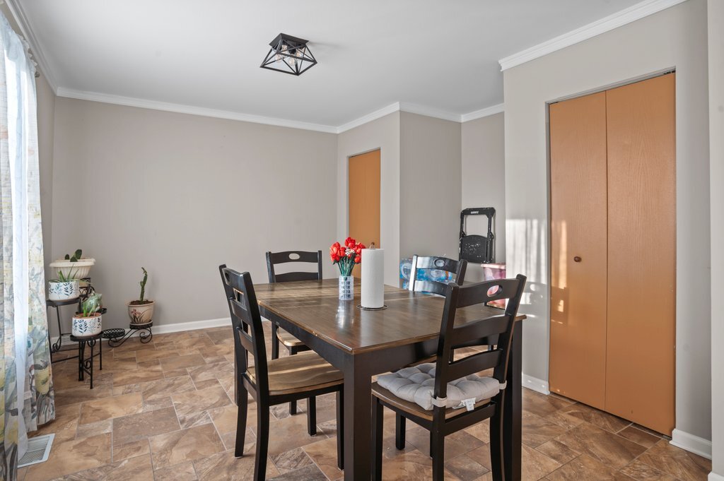 232 Stamford Lane Romeoville, IL 60446 - Photo 14 of 48 a view of a dining room with furniture and a potted plant