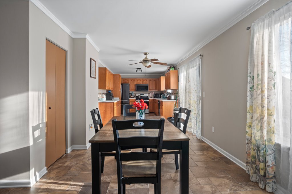 232 Stamford Lane Romeoville, IL 60446 - Photo 15 of 48 a view of a dining room with furniture and window