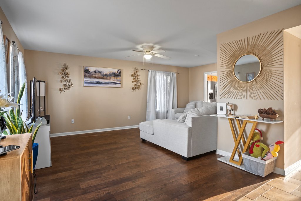 232 Stamford Lane Romeoville, IL 60446 - Photo 18 of 48 a living room with furniture and a flat screen tv