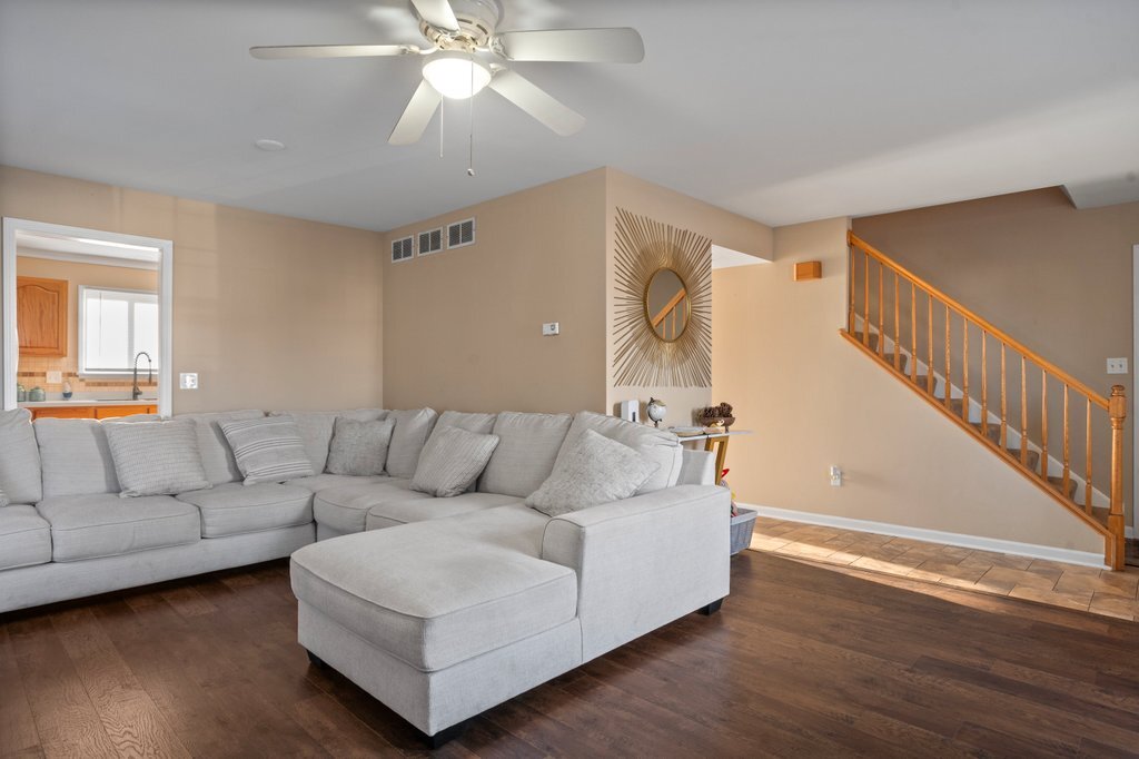 232 Stamford Lane Romeoville, IL 60446 - Photo 19 of 48 a living room with furniture and a wooden floor