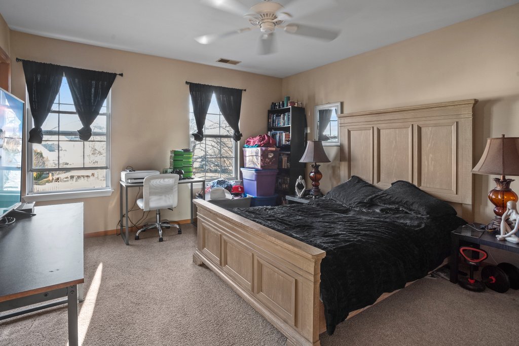 232 Stamford Lane Romeoville, IL 60446 - Photo 21 of 48 a living room with furniture a flat screen tv and a large window