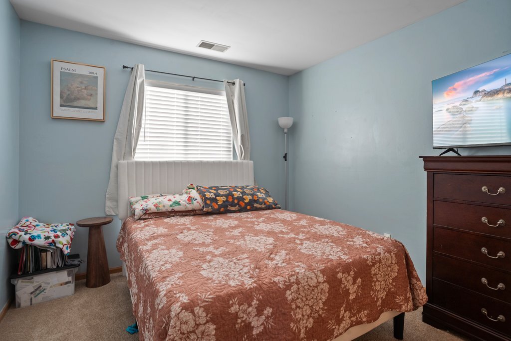 232 Stamford Lane Romeoville, IL 60446 - Photo 22 of 48 a bedroom with a bed and a dresser