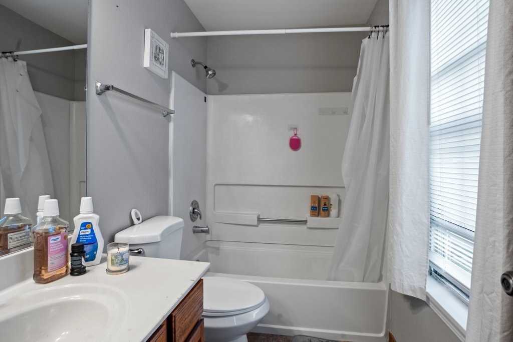 232 Stamford Lane Romeoville, IL 60446 - Photo 31 of 48 a bathroom with a sink a toilet and a shower curtain