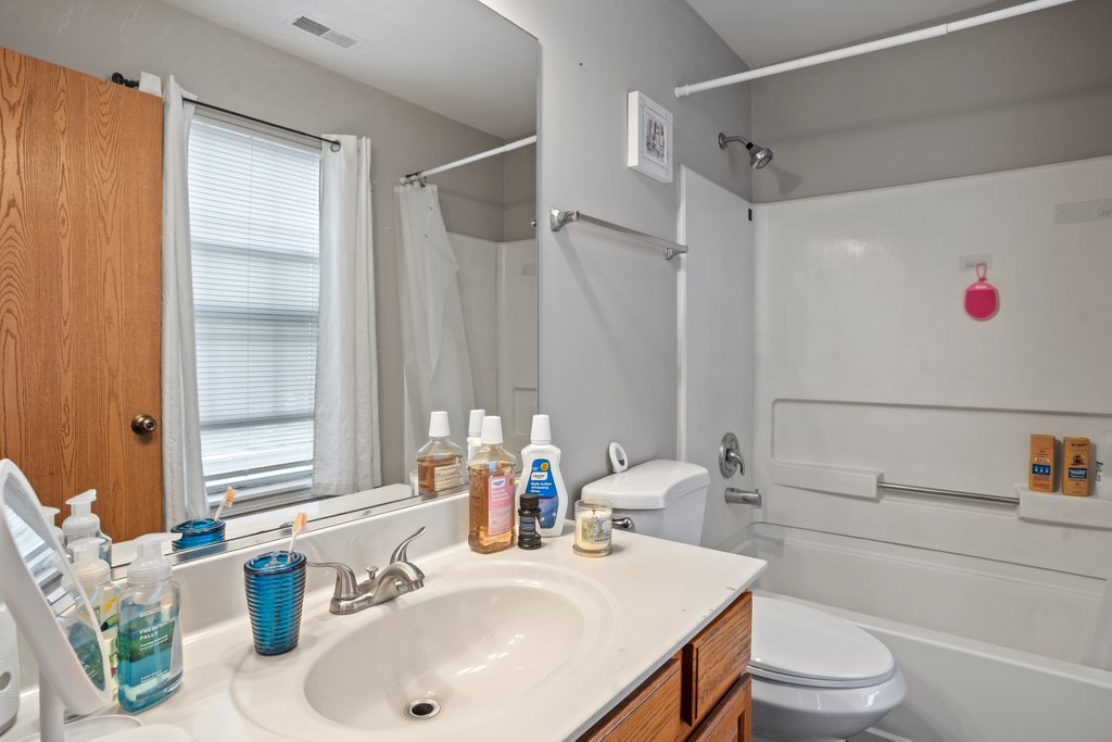 232 Stamford Lane Romeoville, IL 60446 - Photo 32 of 48 a bathroom with a sink vanity mirror and toilet