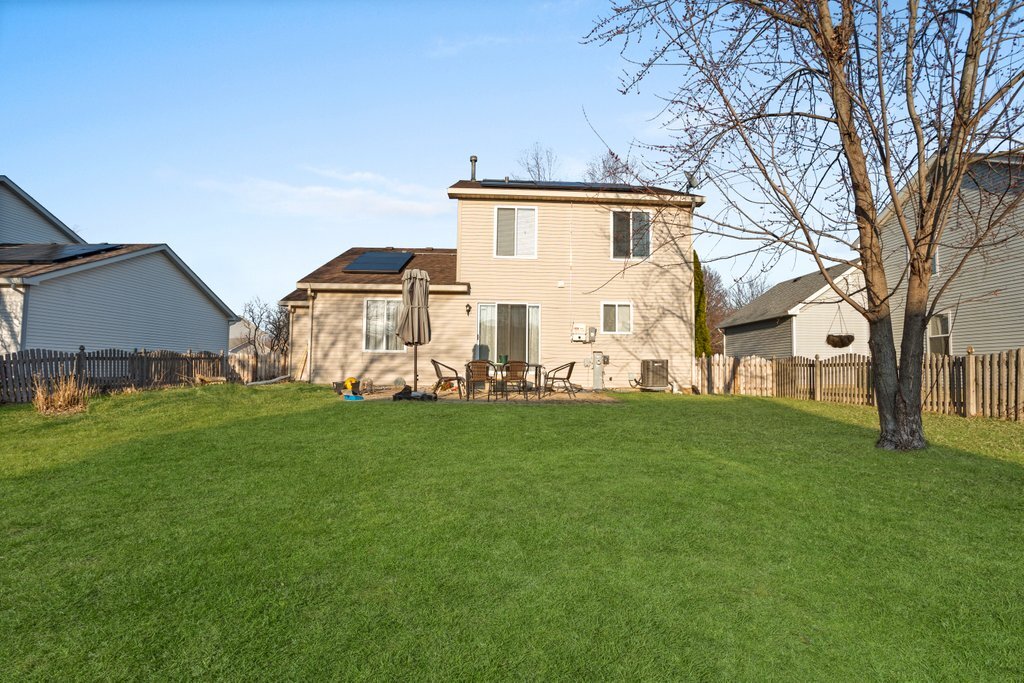 232 Stamford Lane Romeoville, IL 60446 - Photo 34 of 48 a view of a backyard with plants and large trees