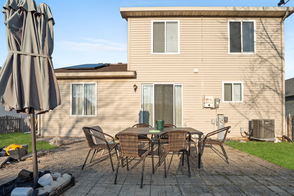 232 Stamford Lane Romeoville, IL 60446 - Photo 36 of 48 a view of a dinning table and chairs in patio of the house