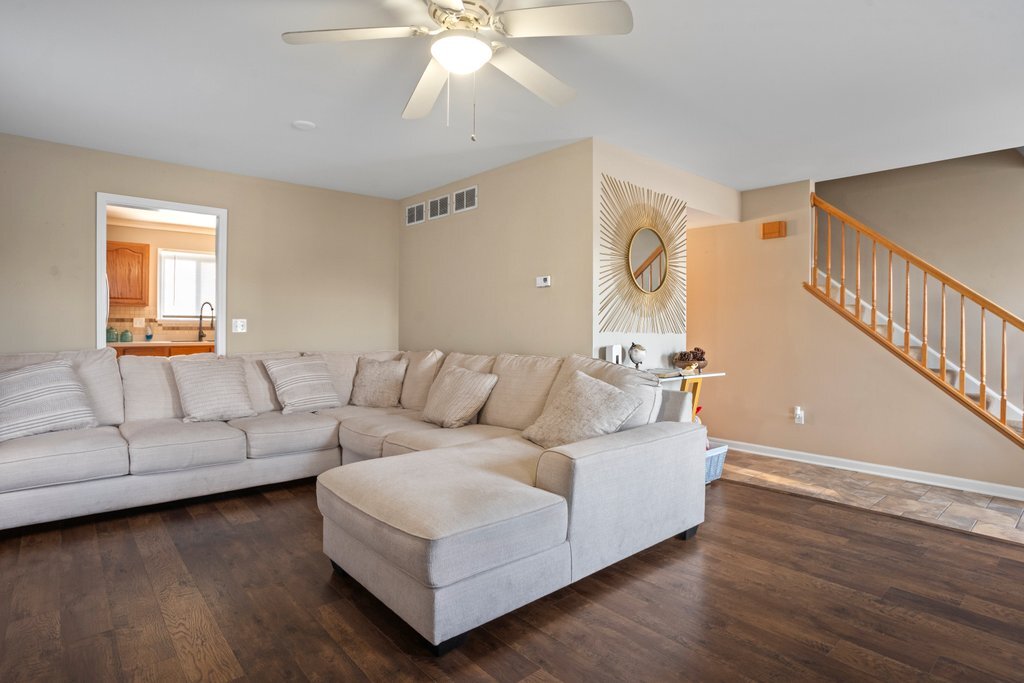 232 Stamford Lane Romeoville, IL 60446 - Photo 6 of 48 a living room with furniture and a wooden floor