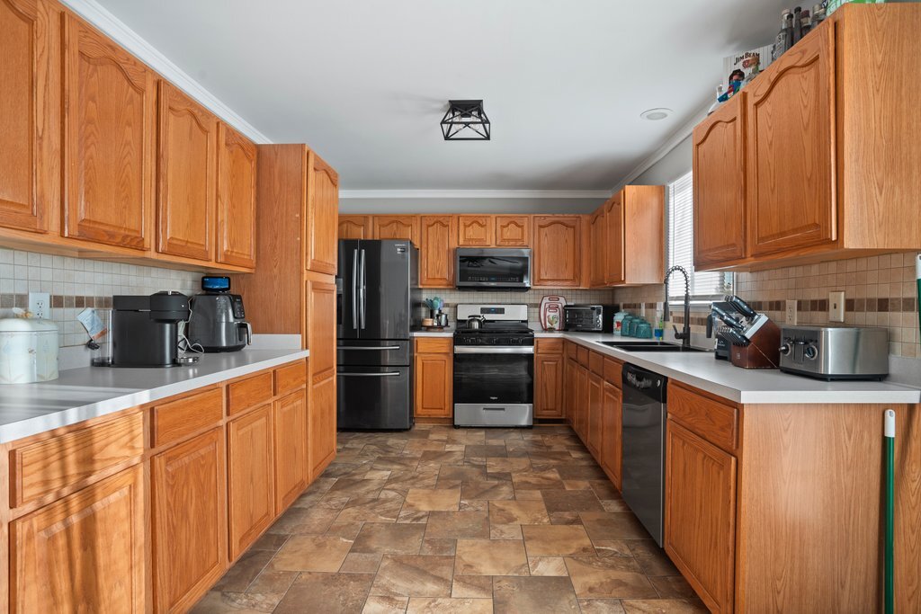 232 Stamford Lane Romeoville, IL 60446 - Photo 10 of 48 a kitchen with stainless steel appliances granite countertop a stove a sink dishwasher and a refrigerator