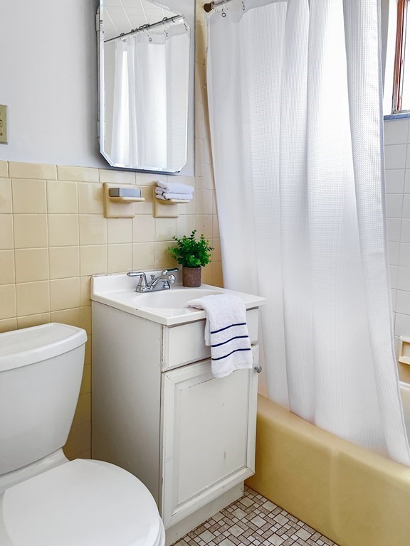 7 Gorham Road Medford, MA 02155 - Photo 15 of 42 a bathroom with a sink a toilet and a mirror