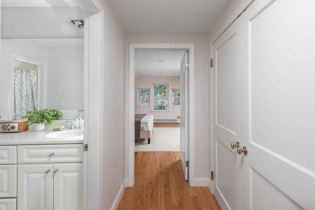 7 Gorham Road Medford, MA 02155 - Photo 23 of 42 a view of a hallway with wooden floor and a bathroom