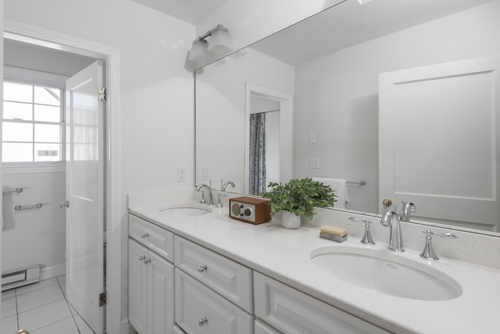 7 Gorham Road Medford, MA 02155 - Photo 28 of 42 a bathroom with a double vanity sink and mirror