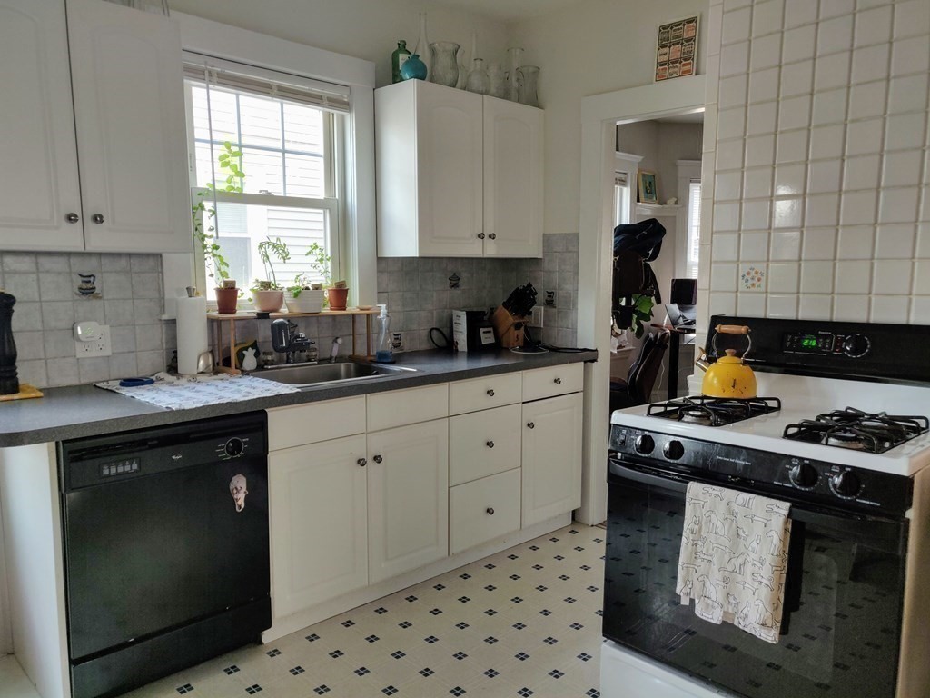 7 Gorham Road Medford, MA 02155 - Photo 33 of 42 a kitchen with a sink stove and cabinets