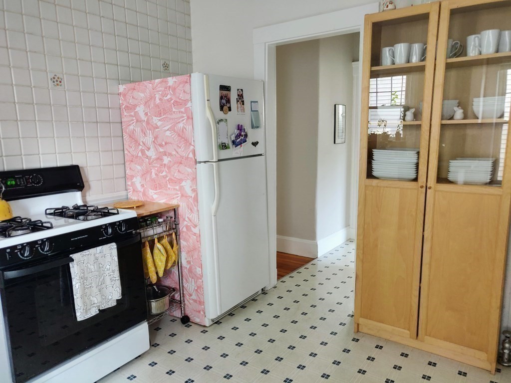 7 Gorham Road Medford, MA 02155 - Photo 34 of 42 a kitchen with a stove and a refrigerator