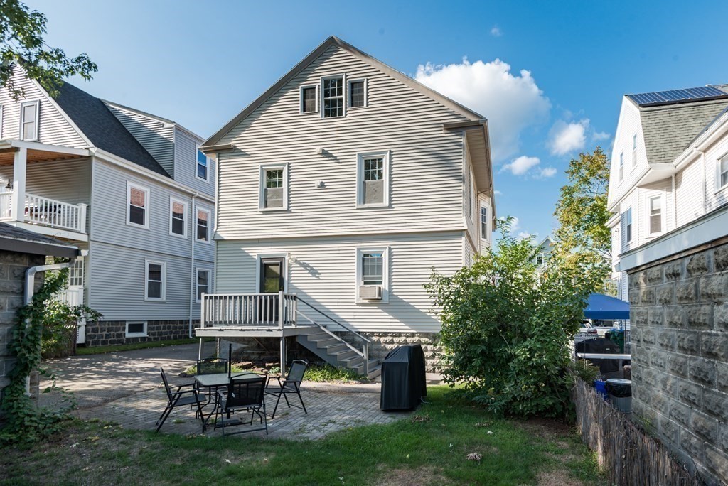 7 Gorham Road Medford, MA 02155 - Photo 41 of 42 a view of a house with patio and a yard