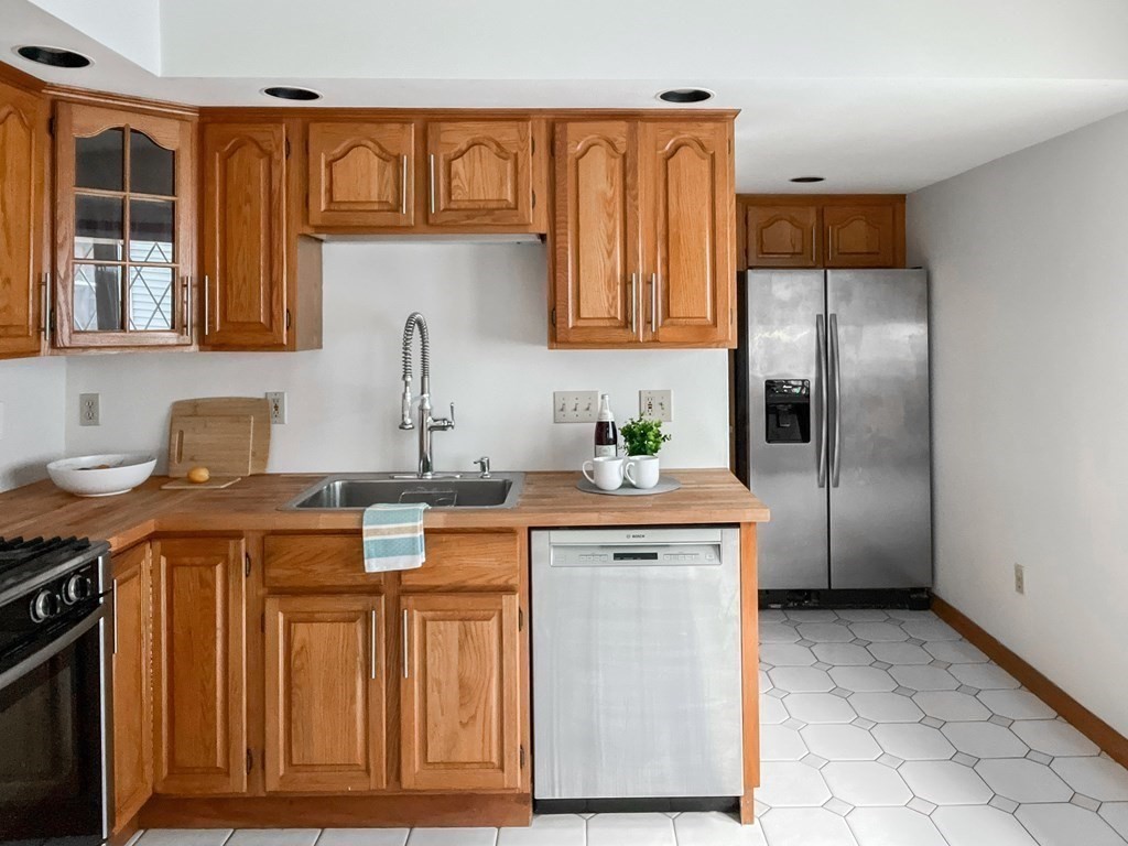 7 Gorham Road Medford, MA 02155 - Photo 10 of 42 a kitchen with stainless steel appliances granite countertop a sink and a refrigerator