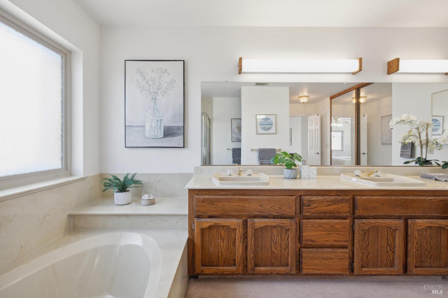 284 Preakness Lane Vallejo, CA 94591 - Photo 42 of 62 a bathroom with a granite countertop sink and a mirror