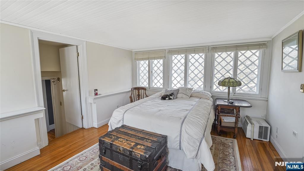 695 Ramapo Valley Road Oakland, NJ 07436 - Photo 32 of 42 a bedroom with a bed and a table in it with window