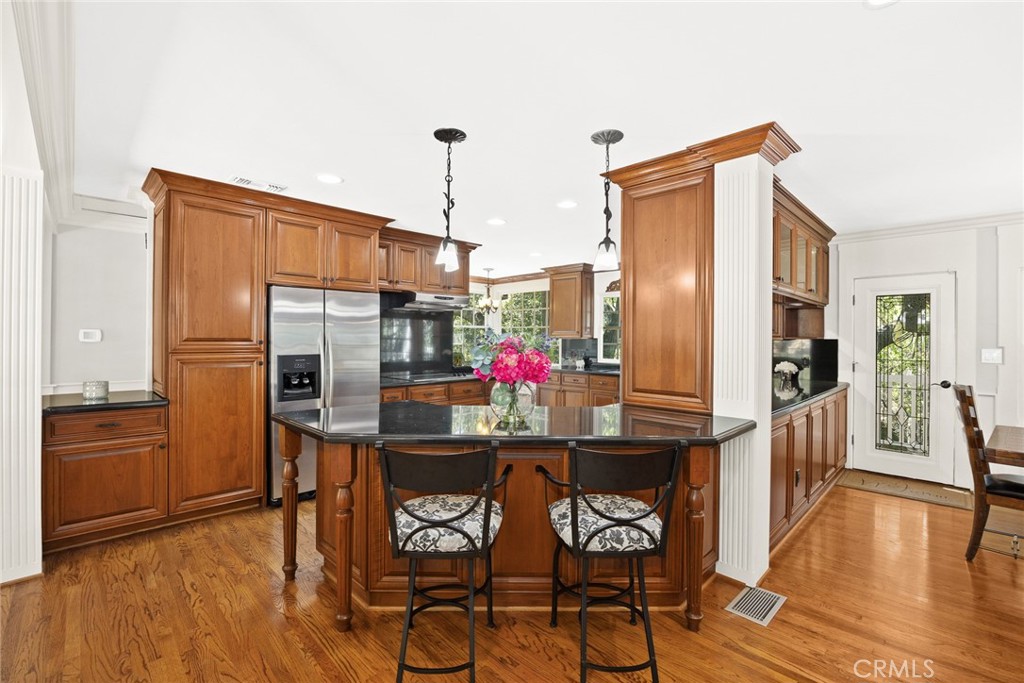 8 Hidden Valley Road Monrovia, CA 91016 - Photo 16 of 45 a kitchen with stainless steel appliances a dining table chairs refrigerator and sink