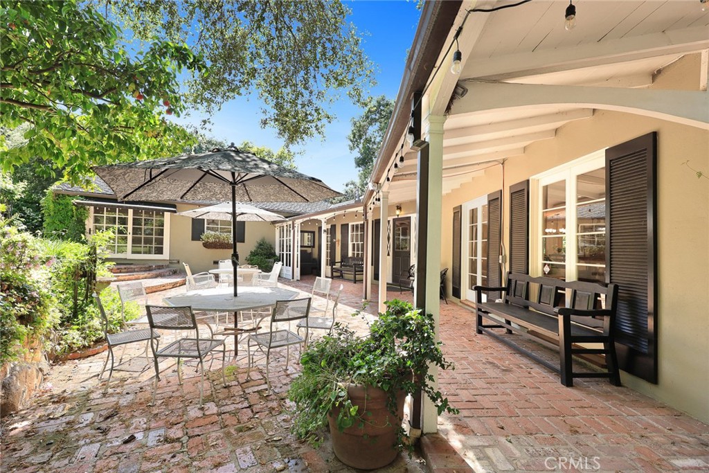 8 Hidden Valley Road Monrovia, CA 91016 - Photo 7 of 45 a view of a patio with couches table and chairs under an umbrella