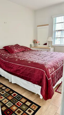 a bedroom with a bed and a window