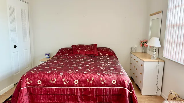 a bedroom with a bed and a window