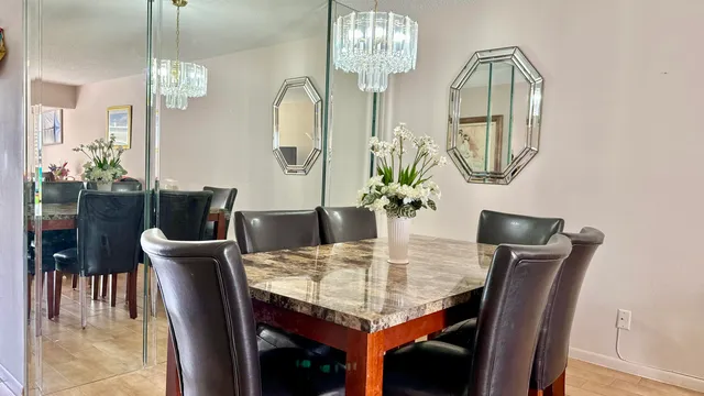 a view of a dining room with furniture and chandelier