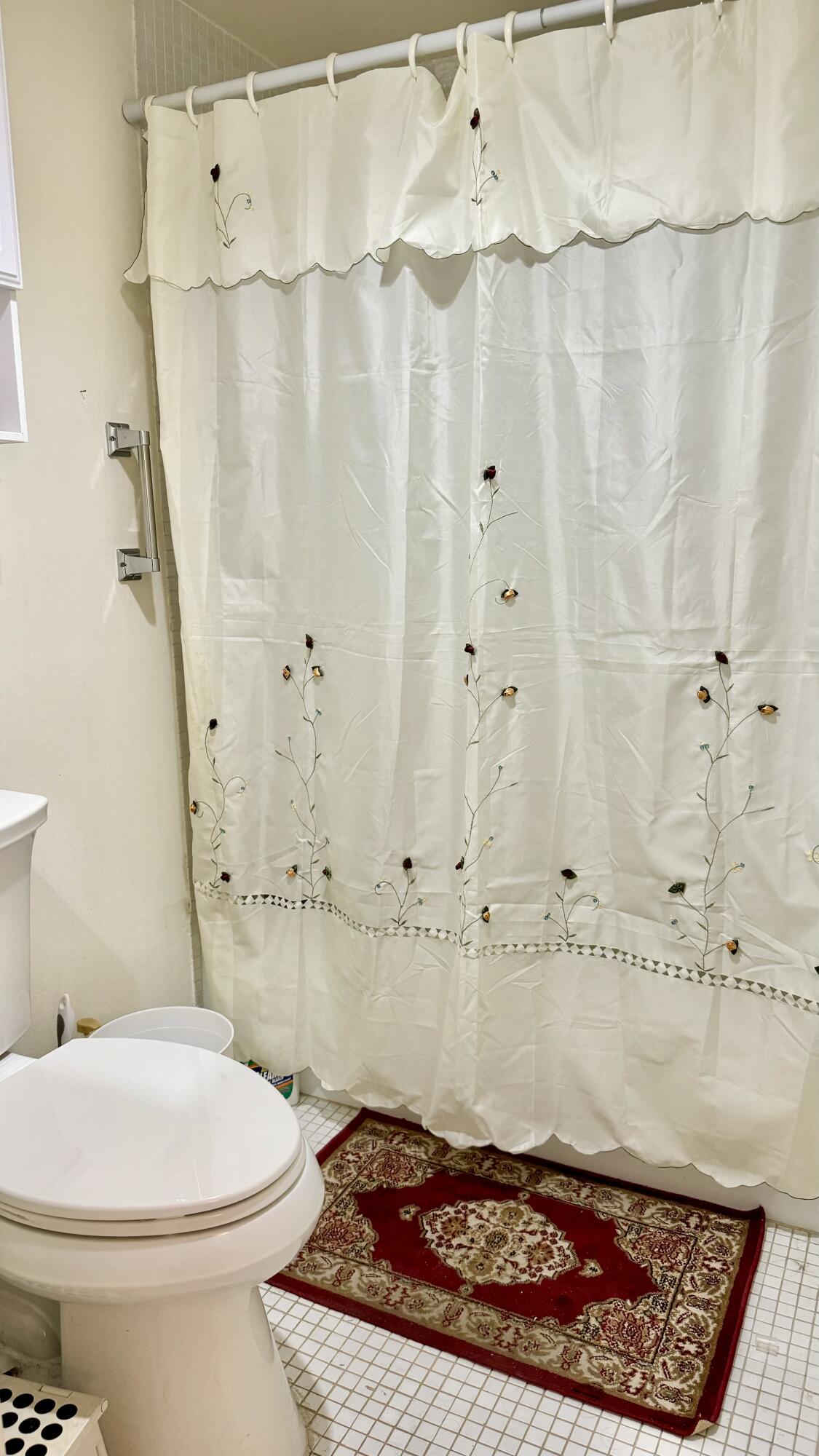 1551 Northwest 20th Avenue, Unit 102 Delray Beach, FL 33445 - Photo 17 of 18 a bathroom with a sink toilet and shower