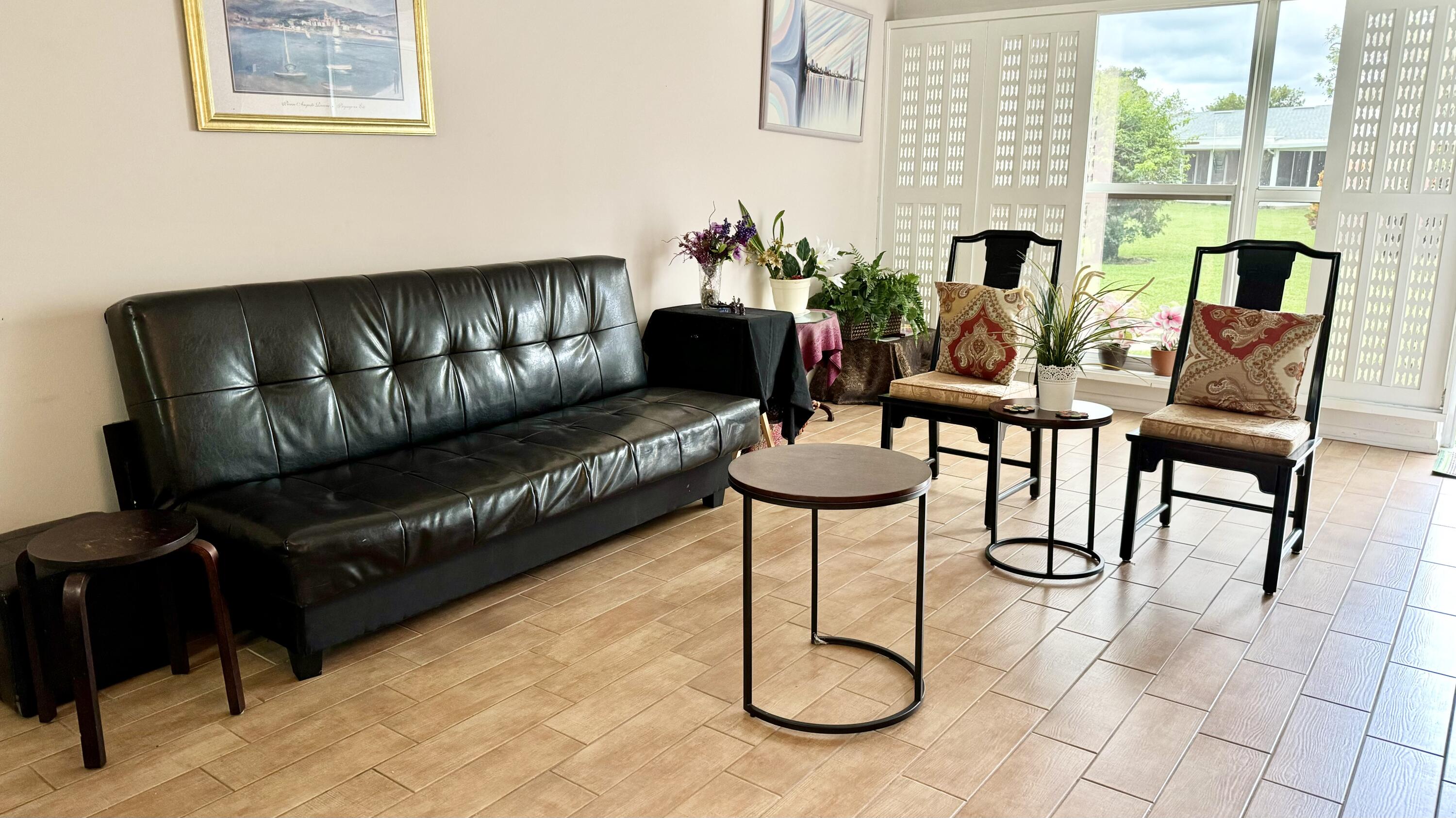 1551 Northwest 20th Avenue, Unit 102 Delray Beach, FL 33445 - Photo 2 of 18 a living room with furniture
