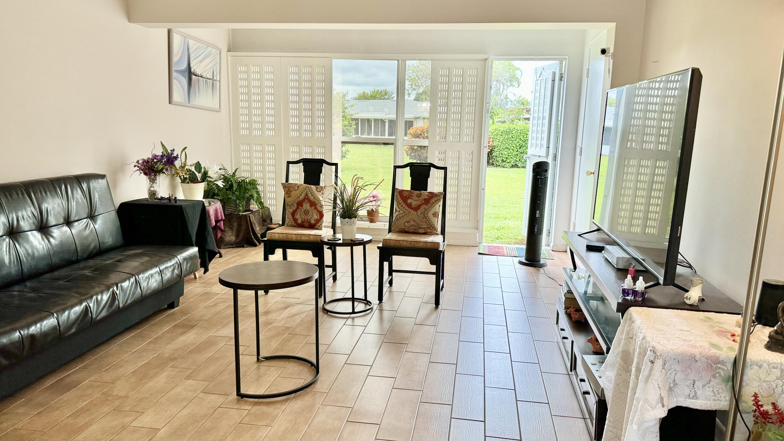1551 Northwest 20th Avenue, Unit 102 Delray Beach, FL 33445 - Photo 6 of 18 a living room with furniture
