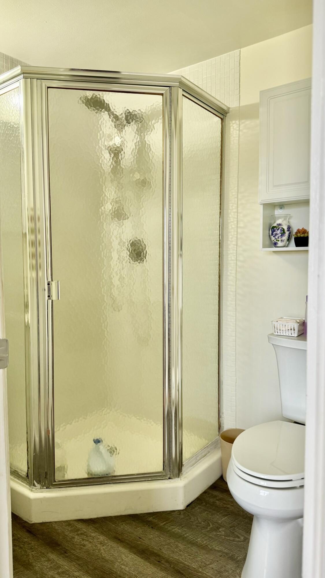 1551 Northwest 20th Avenue, Unit 102 Delray Beach, FL 33445 - Photo 10 of 18 a bathroom with a shower and a toilet