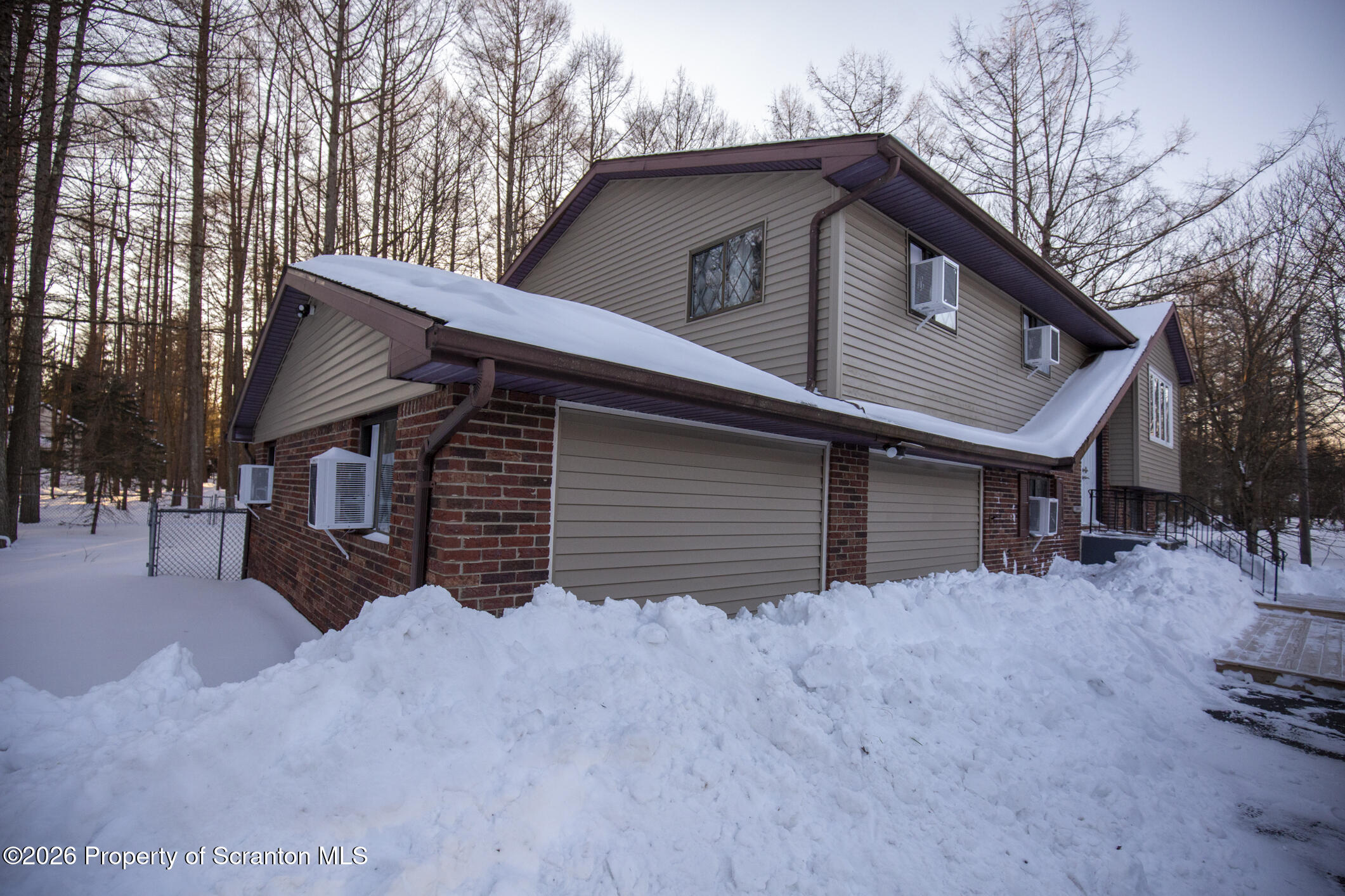 544 Sullivan Trail Long Pond, PA 18334 - Photo 2 of 68 a front view of a house with a yard and garage